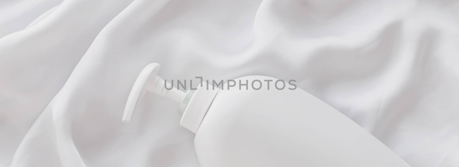 Blank label cosmetic container bottle as product mockup on white silk background, hygiene and healthcare