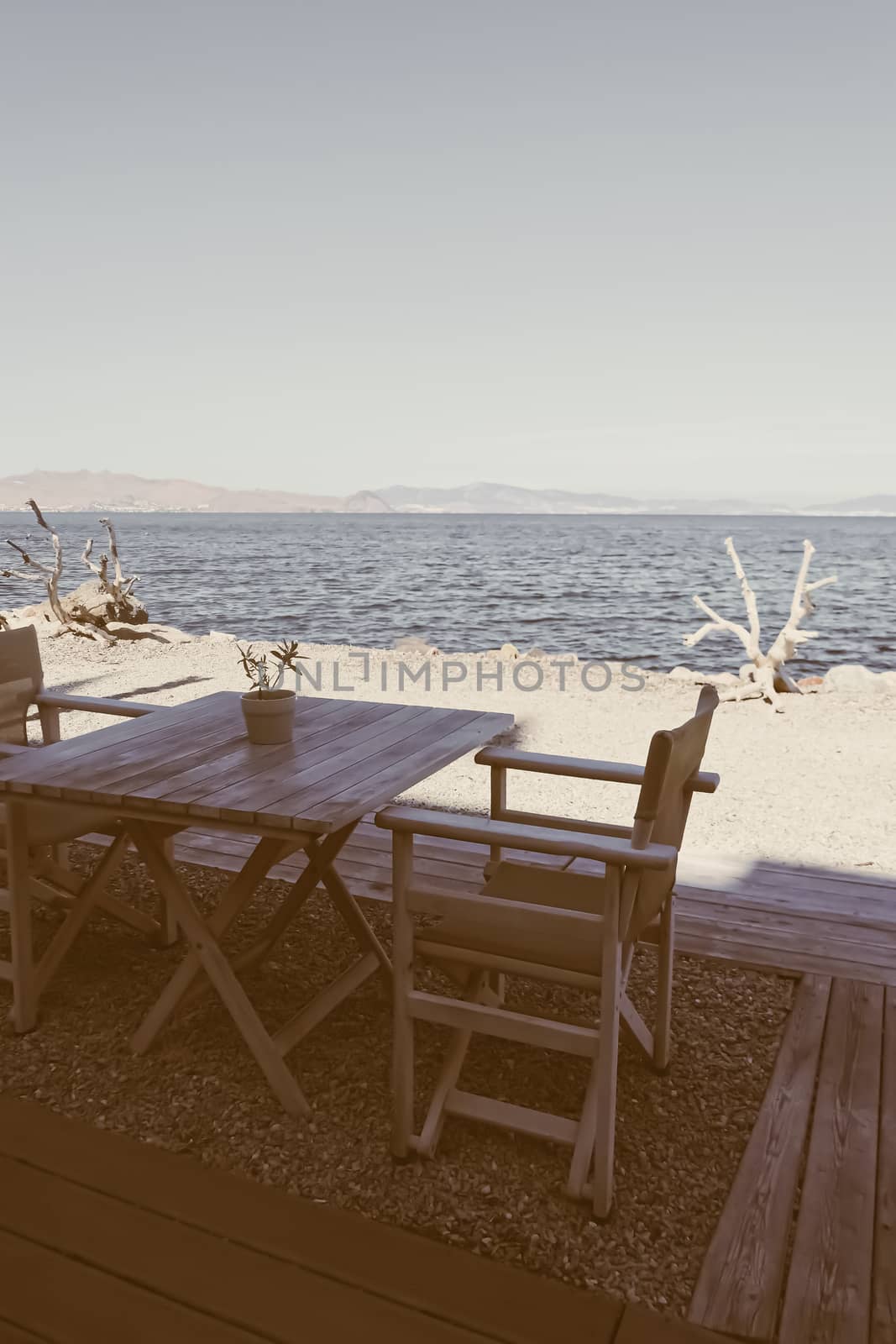 Empty restaurant by the Aegean sea and cruise boat, travel and nature, scene