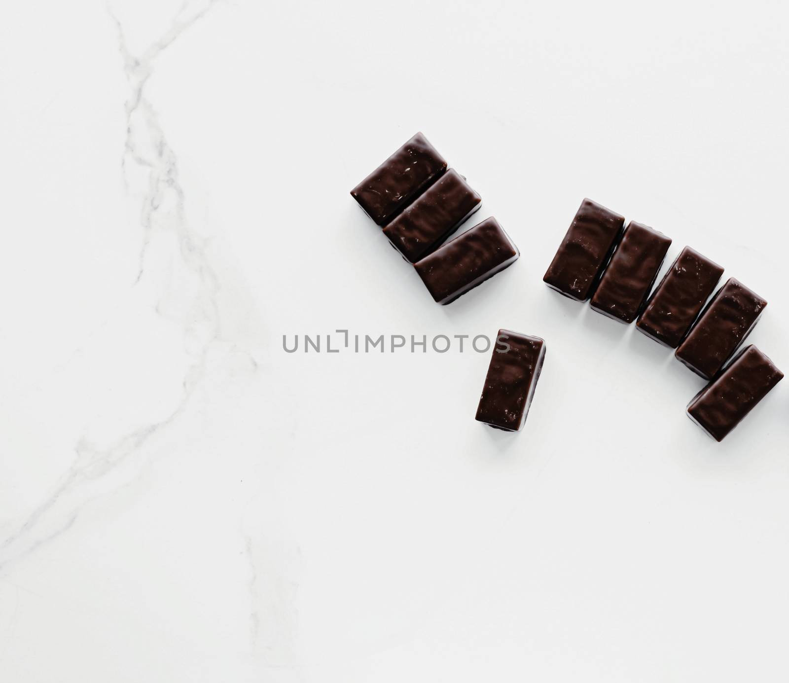 Dark chocolate candies isolated on white background, sweet food and dessert by Anneleven