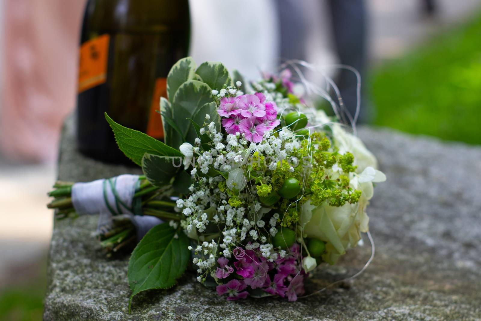 Wedding bouquet and bottle of wine for wedding by AnatoliiFoto