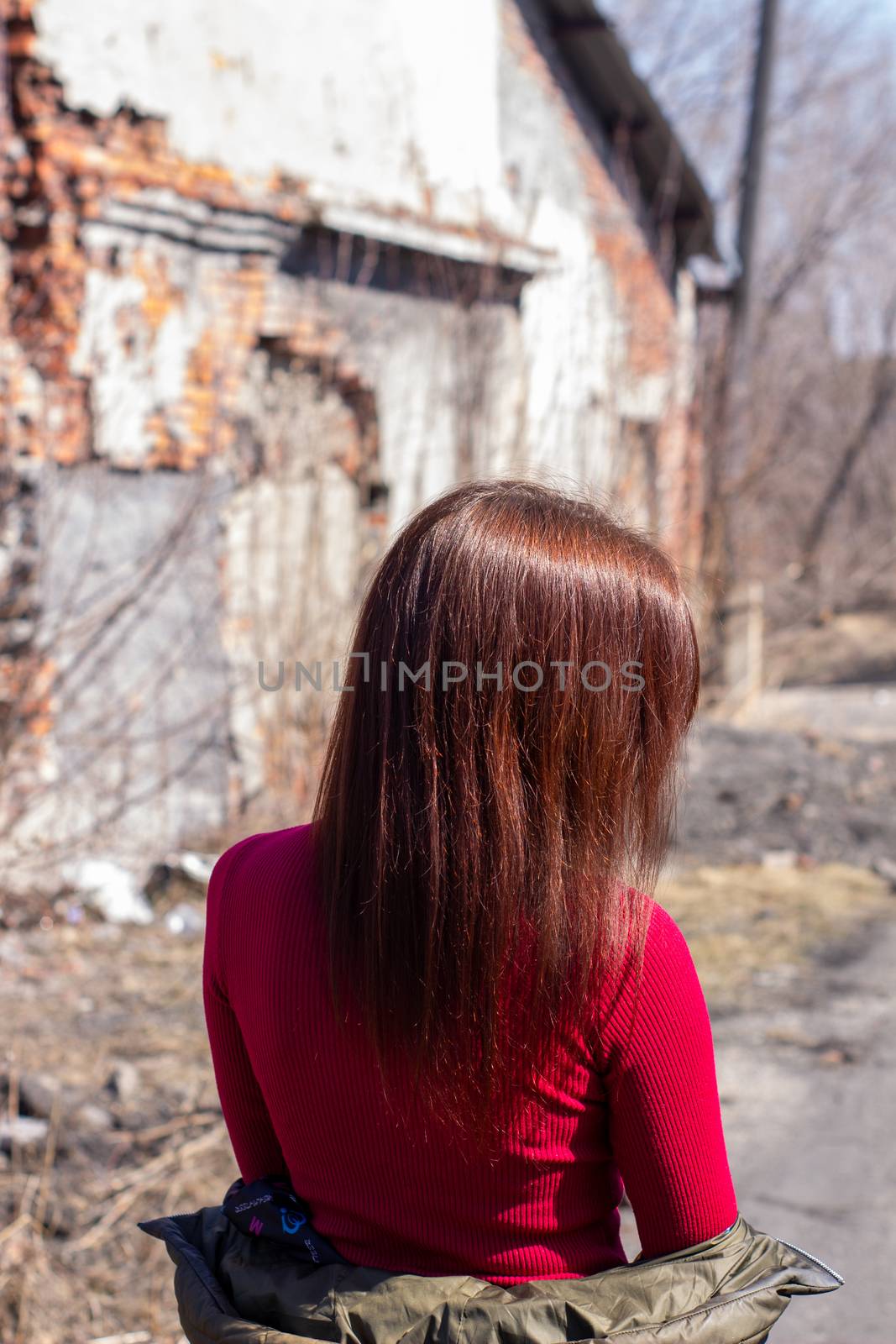 Women's hair brown color on the street, on a Sunny day. Beautiful women's hair with brown ash color.