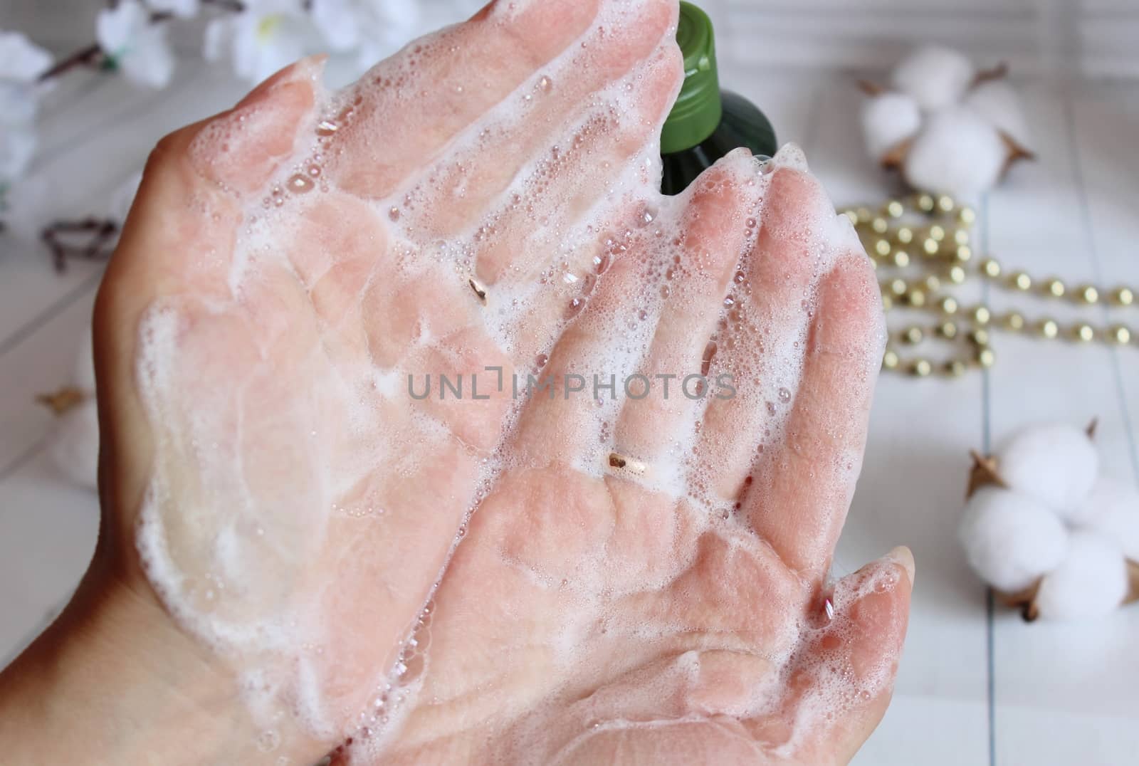 Cream shampoo in women's hands. Body care.