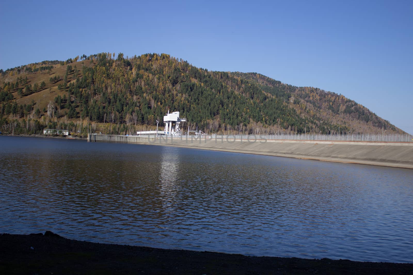 Mountains and shore near a large pond.