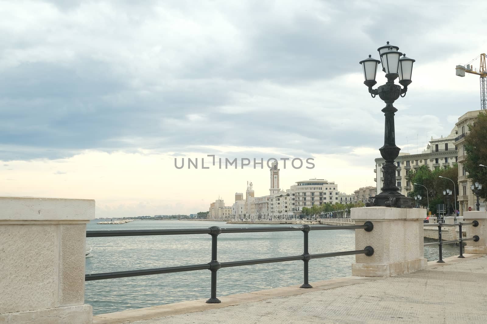 Promenade of Bari with the buildings of the Murattiano village. A parapet and a street lamp on the road that runs along the sea. Bari, Puglia, Italy.