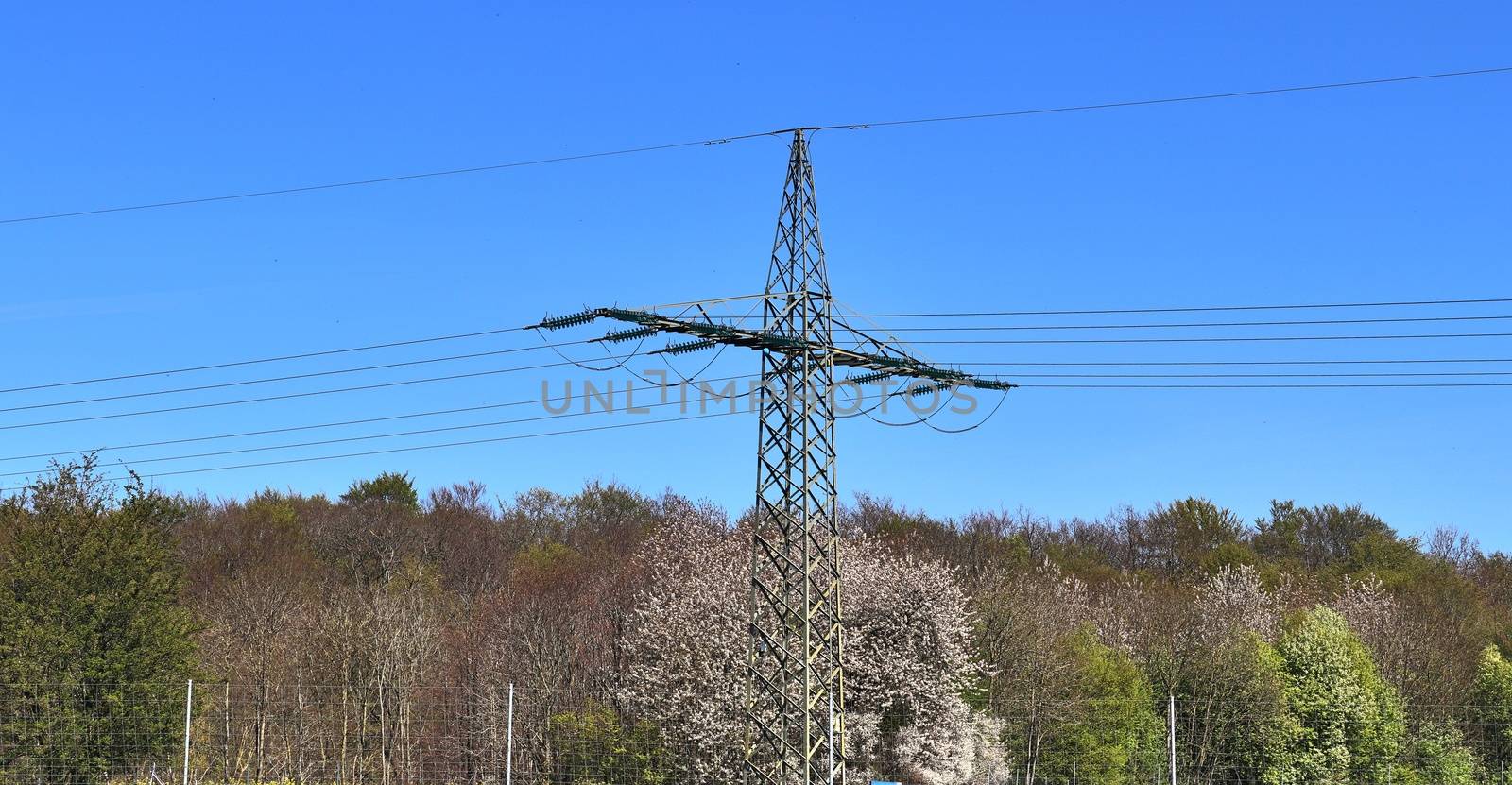 Close up view on a big power pylon transporting electricity in a countryside area in Europe