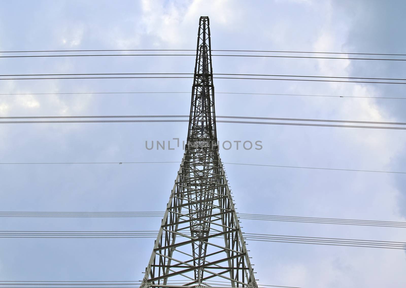 Close up view on a big power pylon transporting electricity in a countryside area in Europe