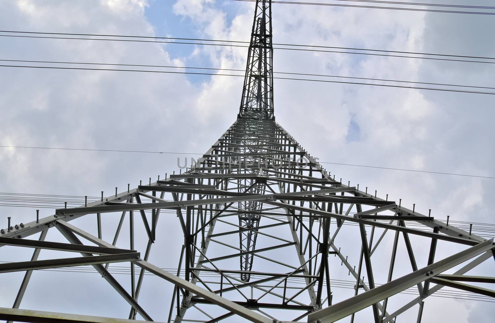 Close up view on a big power pylon transporting electricity in a countryside area in Europe