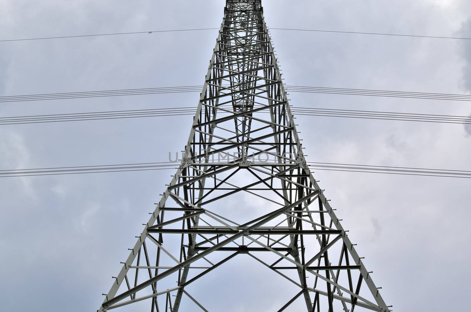 Close up view on a big power pylon transporting electricity in a countryside area in Europe