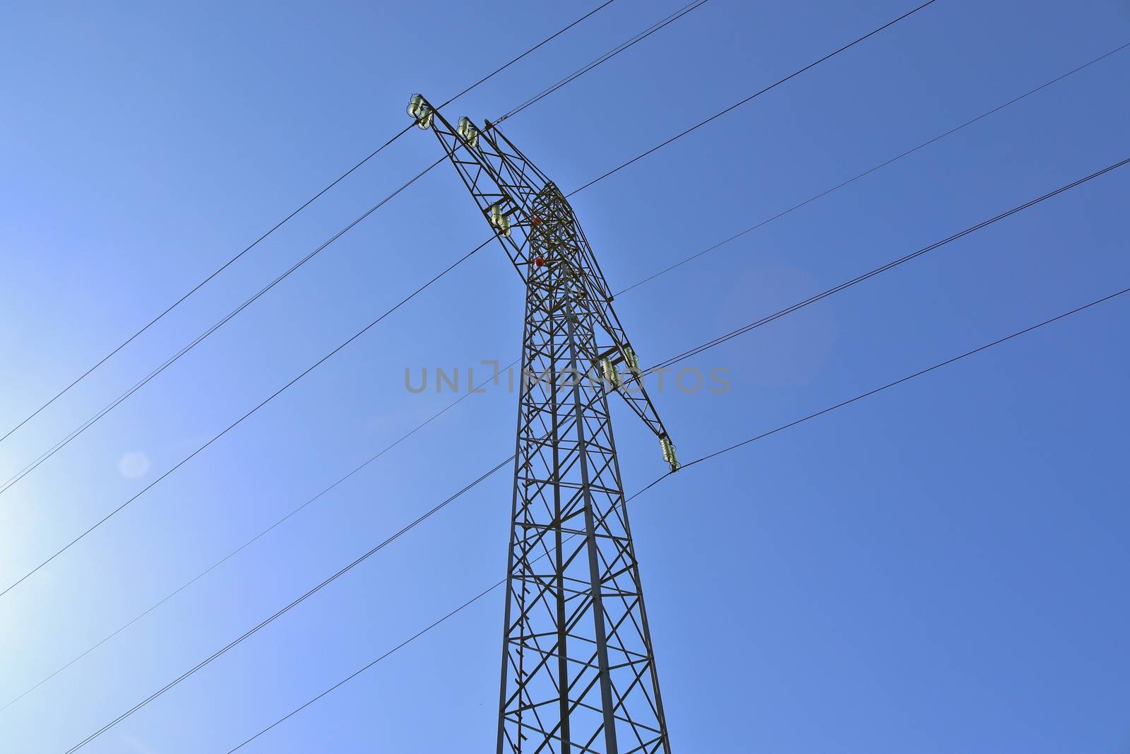 Close up view on a big power pylon transporting electricity in a countryside area in Europe