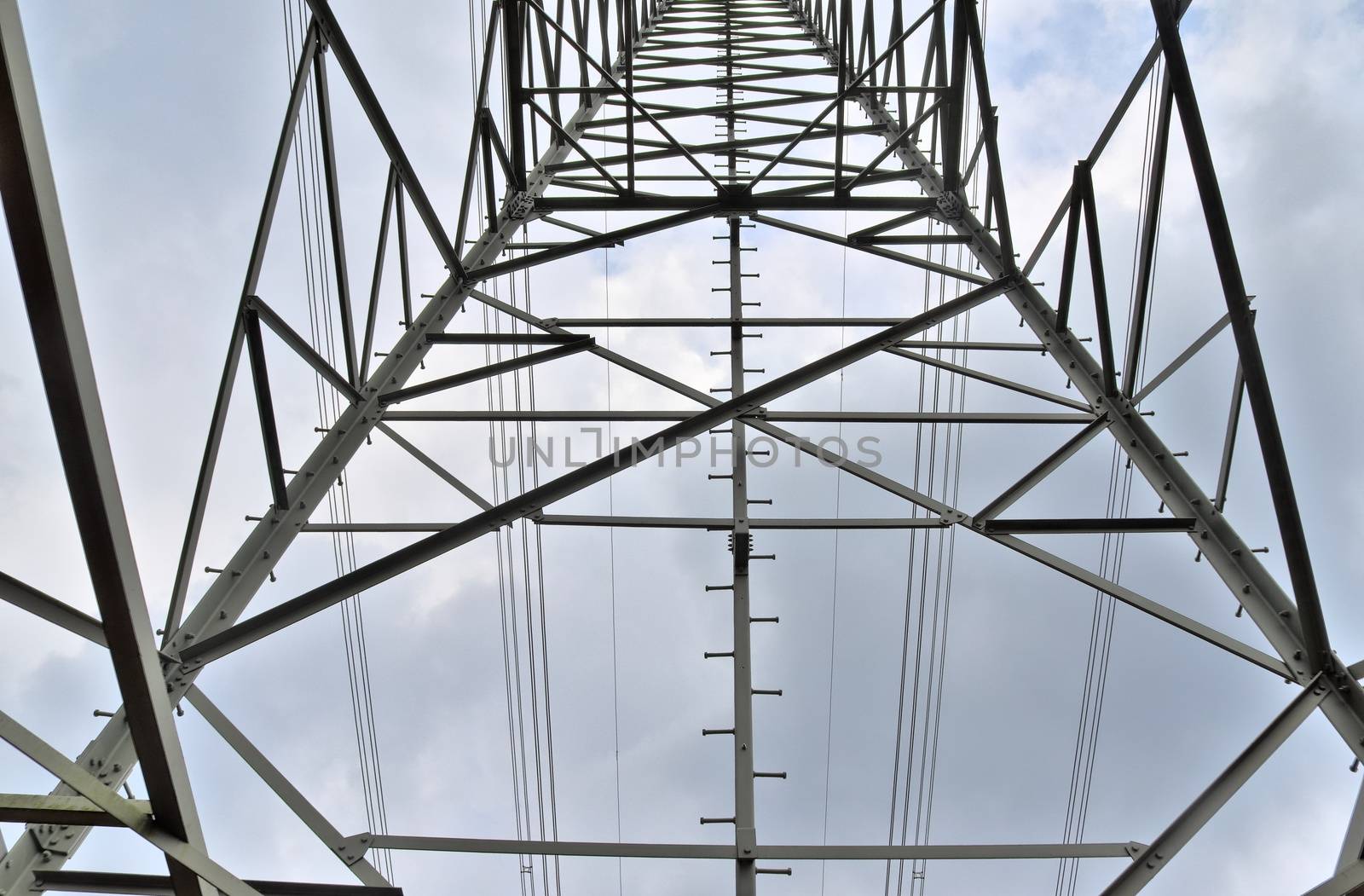 Close up view on a big power pylon transporting electricity in a countryside area in Europe