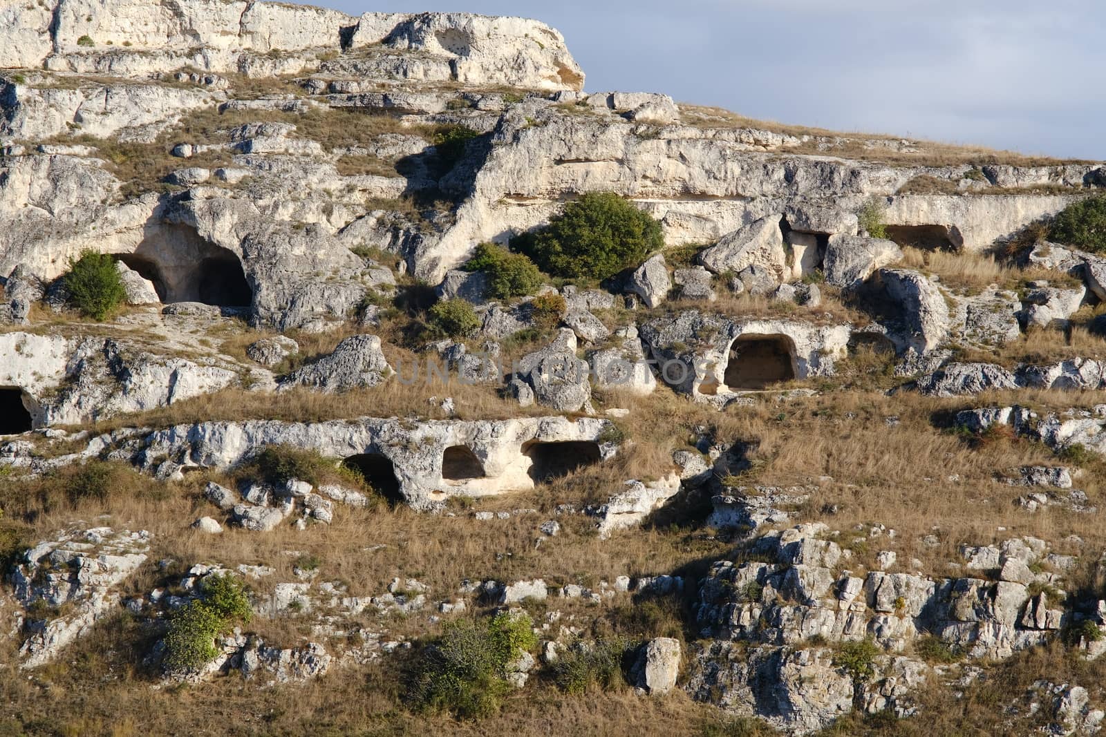 Mountain in front of the city of Matera in Italy. Caves used as dwellings in prehistoric times