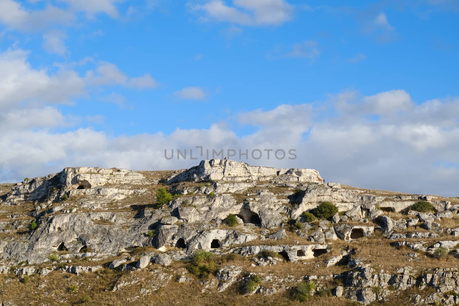 Mountain in front of the city of Matera in Italy. Caves used as  by Paolo_Grassi