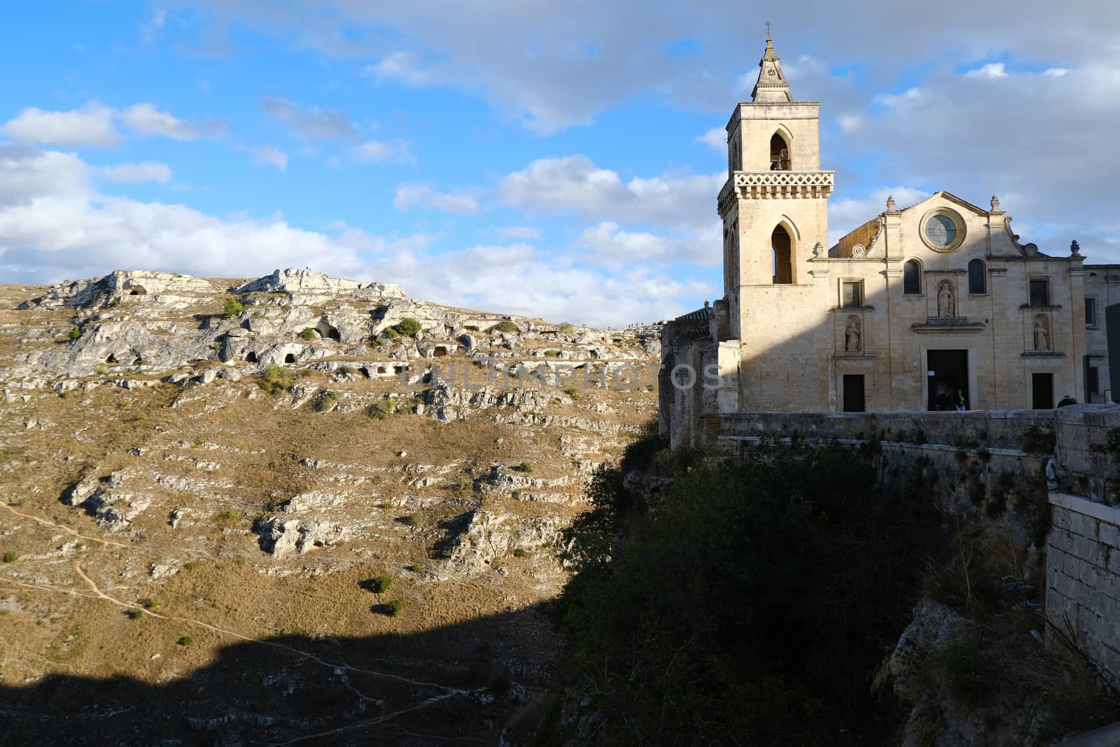 Matera, Basilicata, Italy. About 11/2019. Church of San Pietro Caveoso in Matera. In the background the Mountains with ancient prehistoric caves.