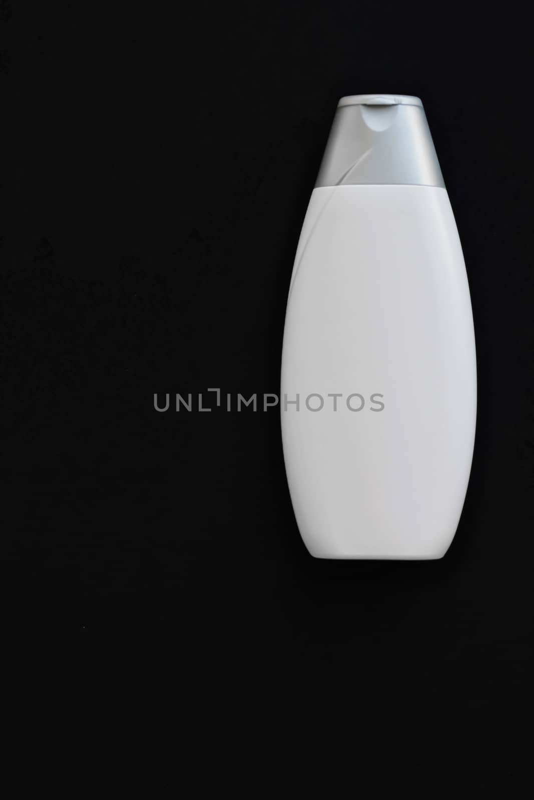 Blank label cosmetic container bottle as product mockup on black background by Anneleven