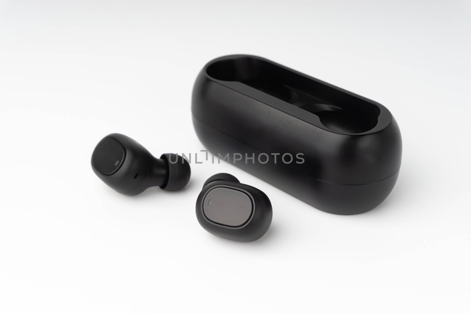 Wireless earbuds or earphones on white background by silverwings