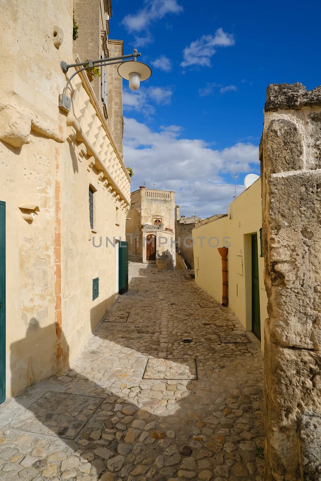 Matera, Basilicata, Italy. About 11/2019. Houses, roads and alleys in the Sassi of Matera. Typical dwellings carved into the rock and with facades of beige tuff blocks.