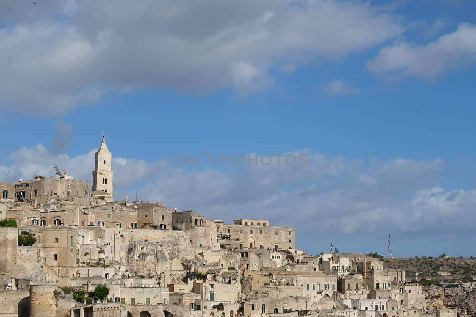 Panorama of houses and of the Sassi of Matera with roofs and streets. Blue sky with 