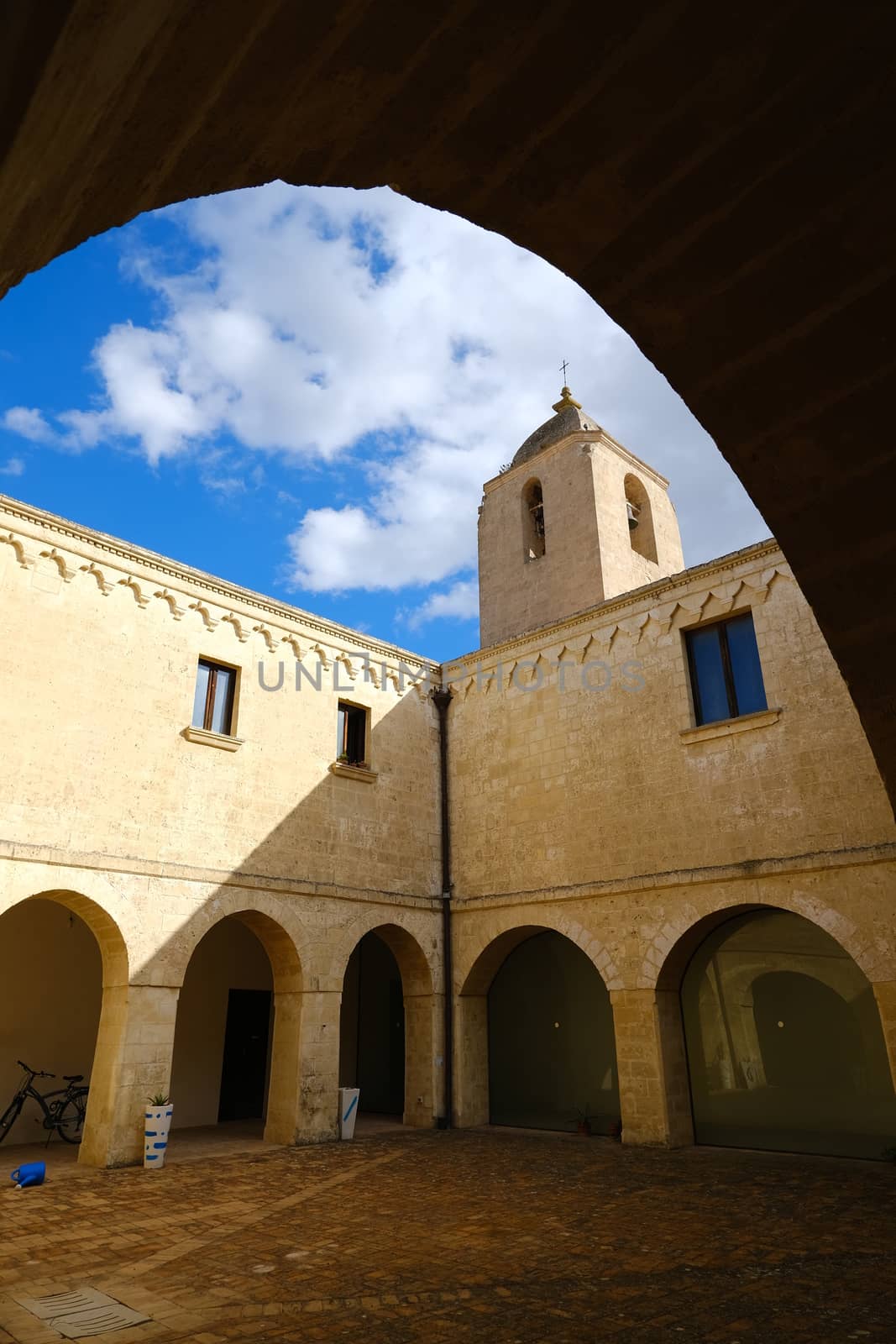 Matera, Italy. About 11/2019. Convent of Sant'Agostino in Matera. Beige stone facade with blue sky and clouds.