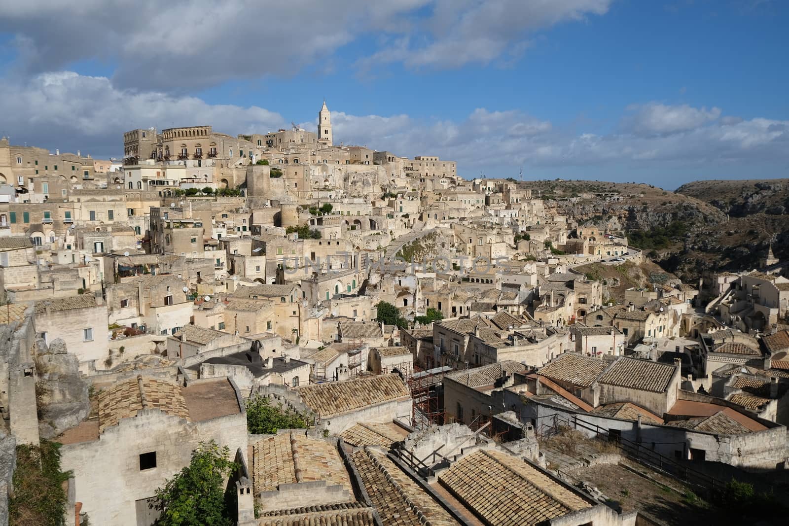 Panorama of houses and of the Sassi of Matera with roofs and streets. Blue sky with 