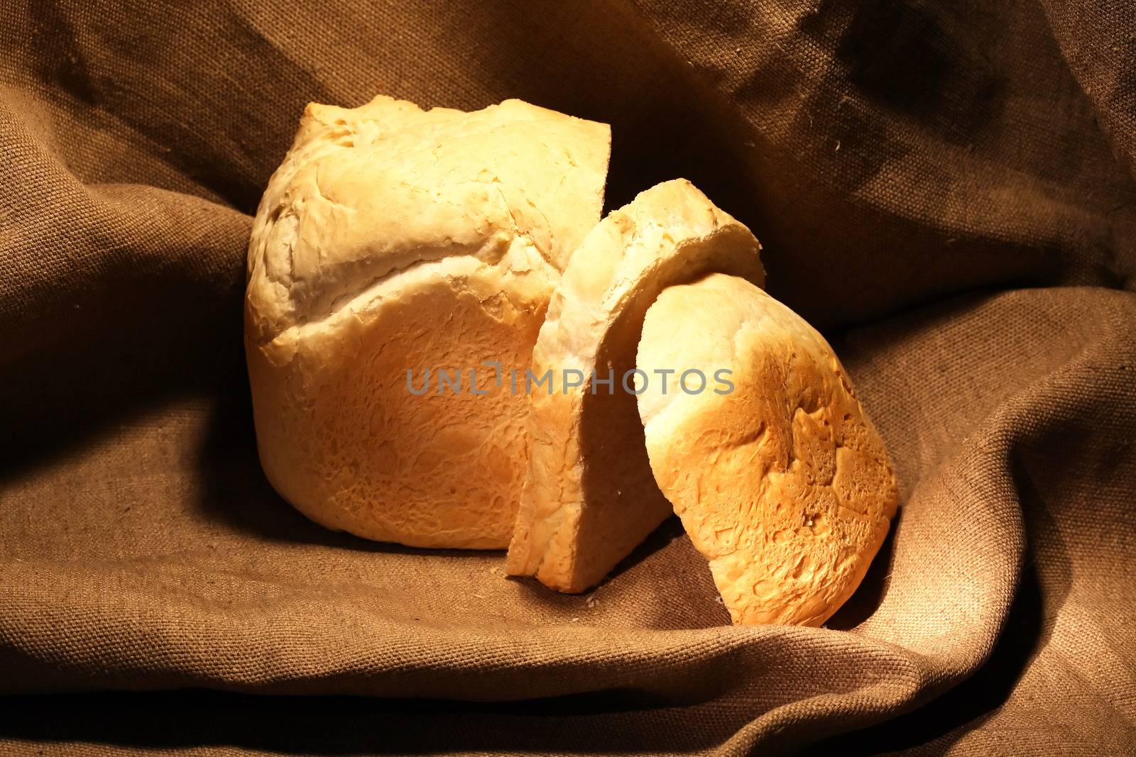 Sliced loaf of white bread on canvas background