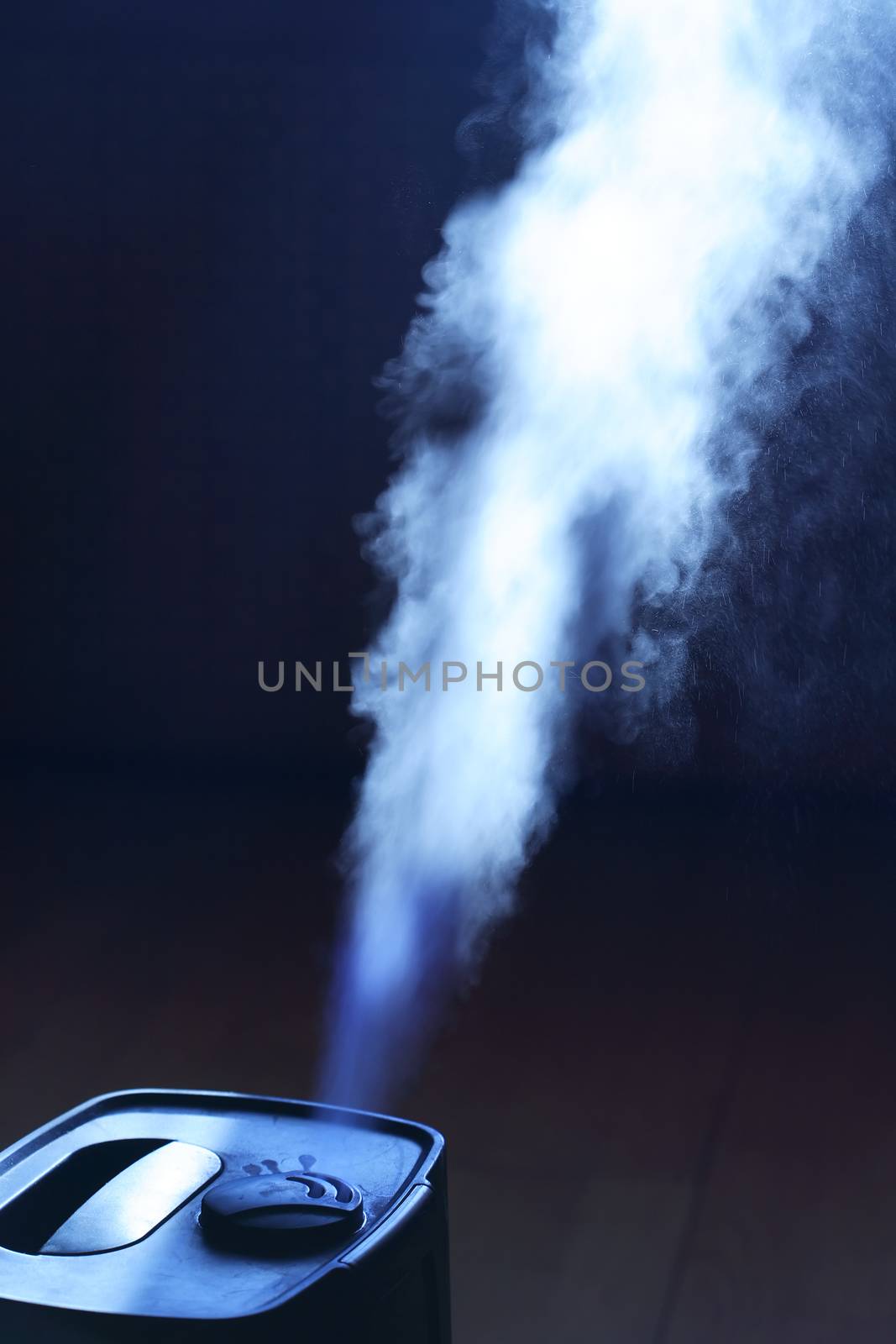 Closeup of home modern humidifier with white water steam