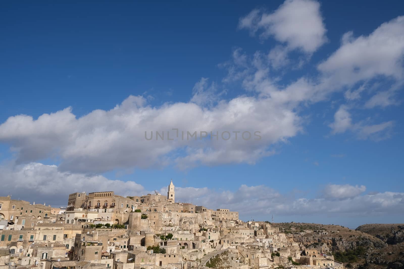 Panorama of houses and of the Sassi of Matera with roofs and streets. Blue sky with 