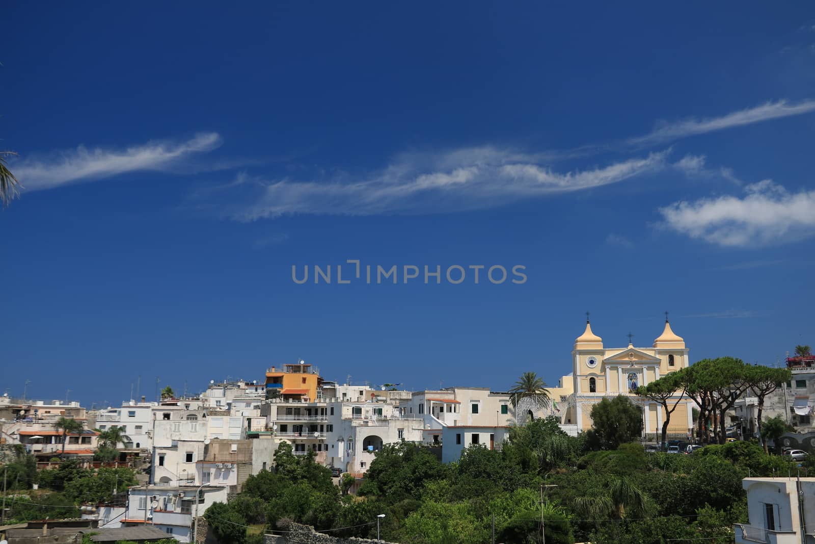 Panorama of the town of Forio d'Ischia, near Naples.  The church of San Vito Martire with the blue sky and clouds in the background.