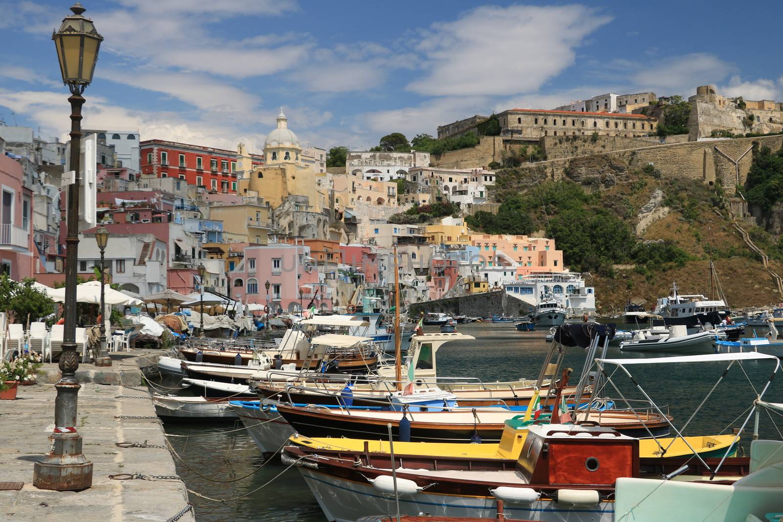 Procida island, Naples, Italy, About the July 2019. Village of Marina Corricella, Procida Island, Mediterranean Sea, near Naples. Colorful houses in the fishing village and boats anchored in the harbor.