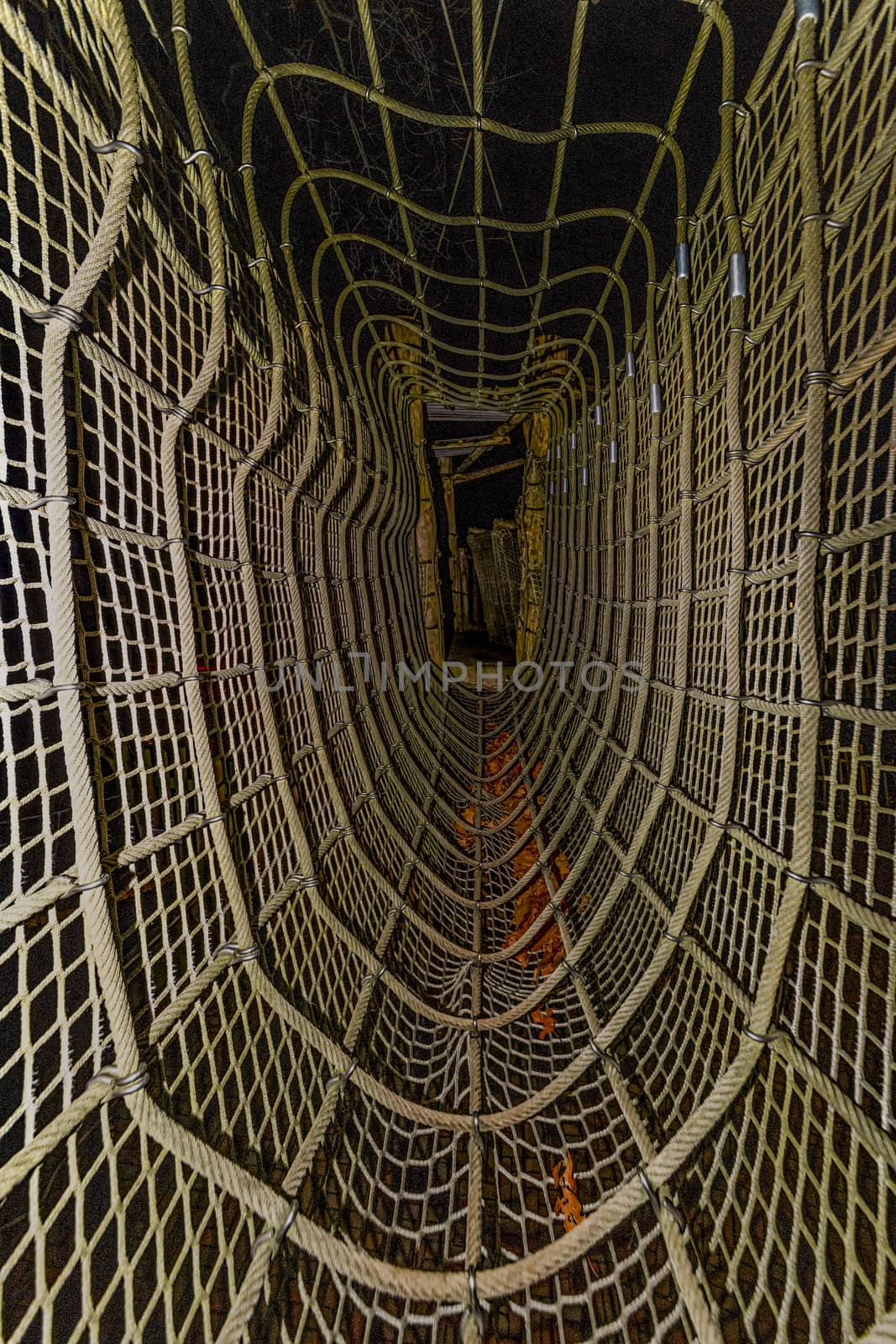 Getting through an outdoor playground with hanging bridge and net at night