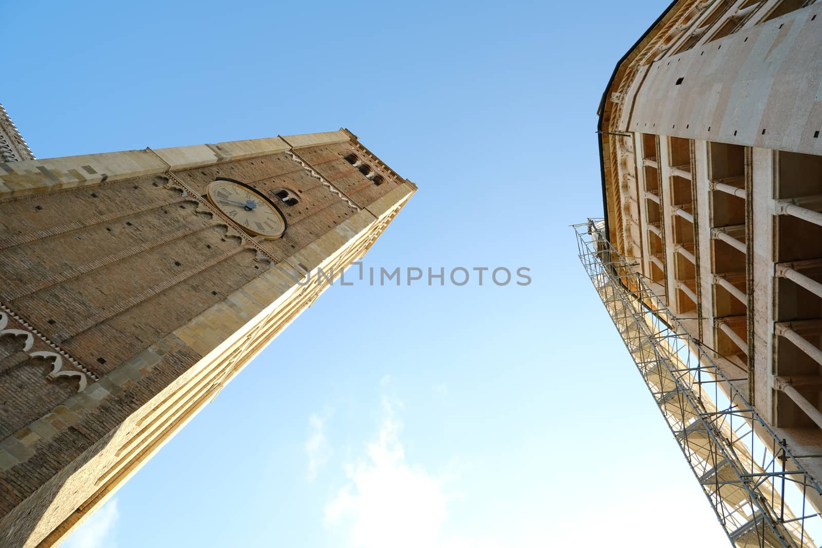 Baptistery of Parma and bell tower of the cathedral. Italian culture capital 2020. Scaffolding for restoration work.