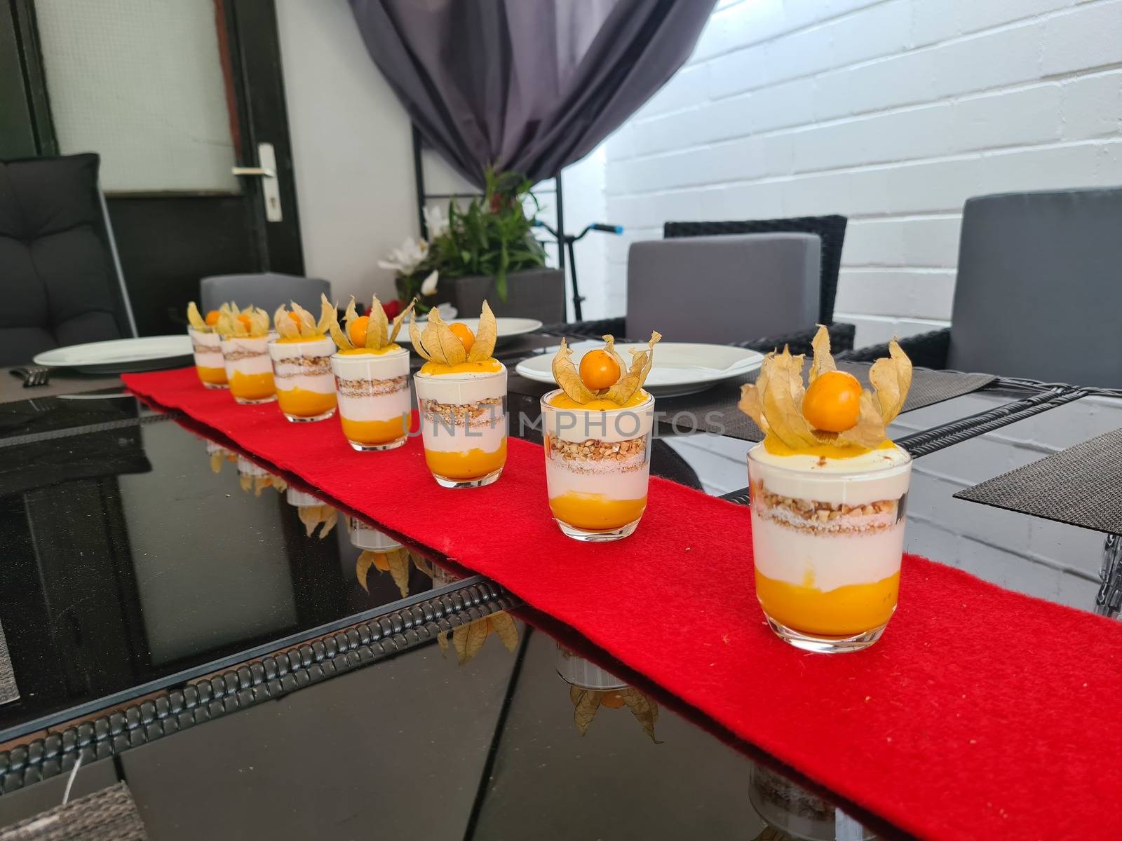 Raspberry dessert, cheesecake, trifle, mouse in a glass on a wooden background.