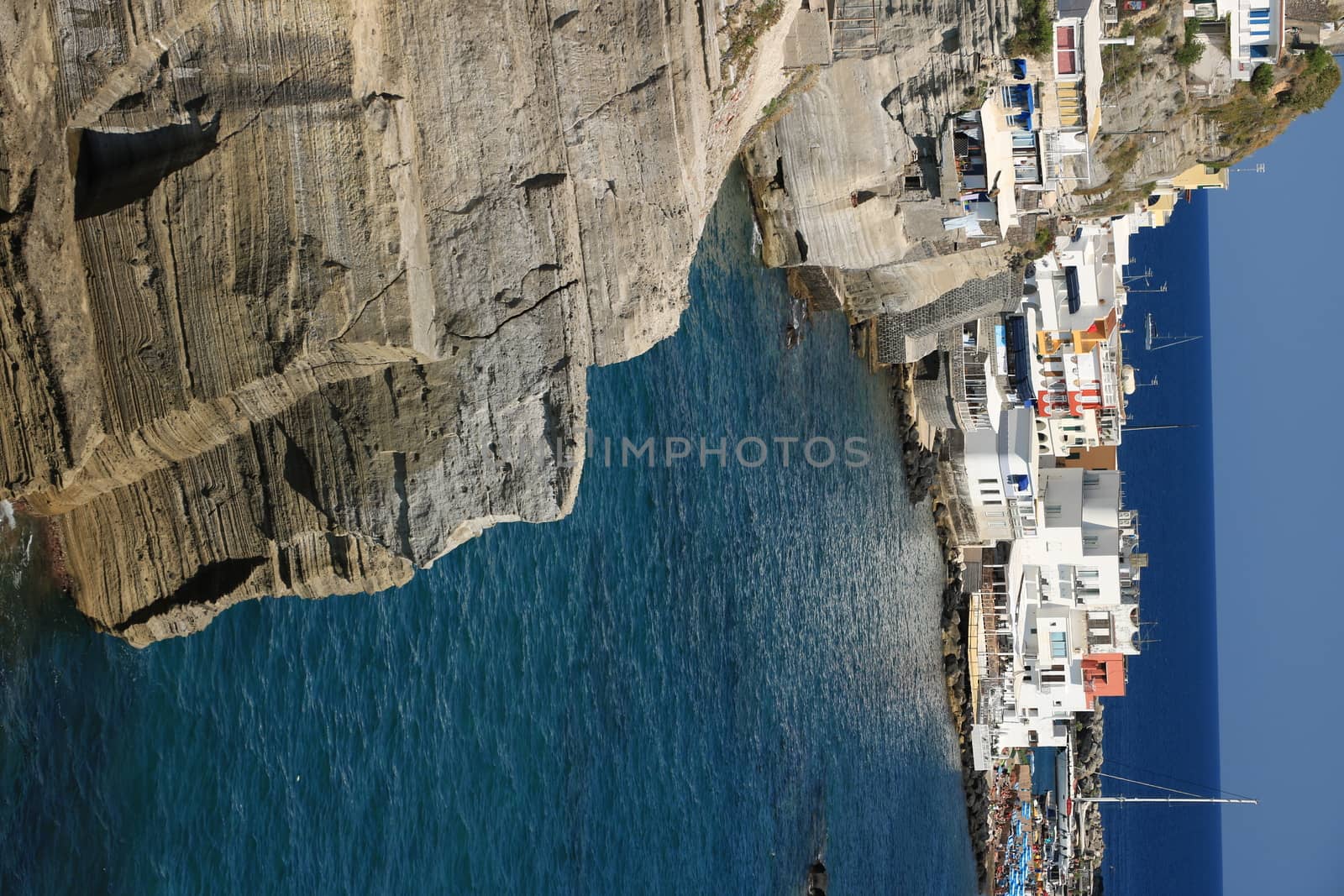 Sant'angelo di Ischia, Mediterranean sea near Naples. The mountain is connected to the mainland by a sandy beach with umbrellas.