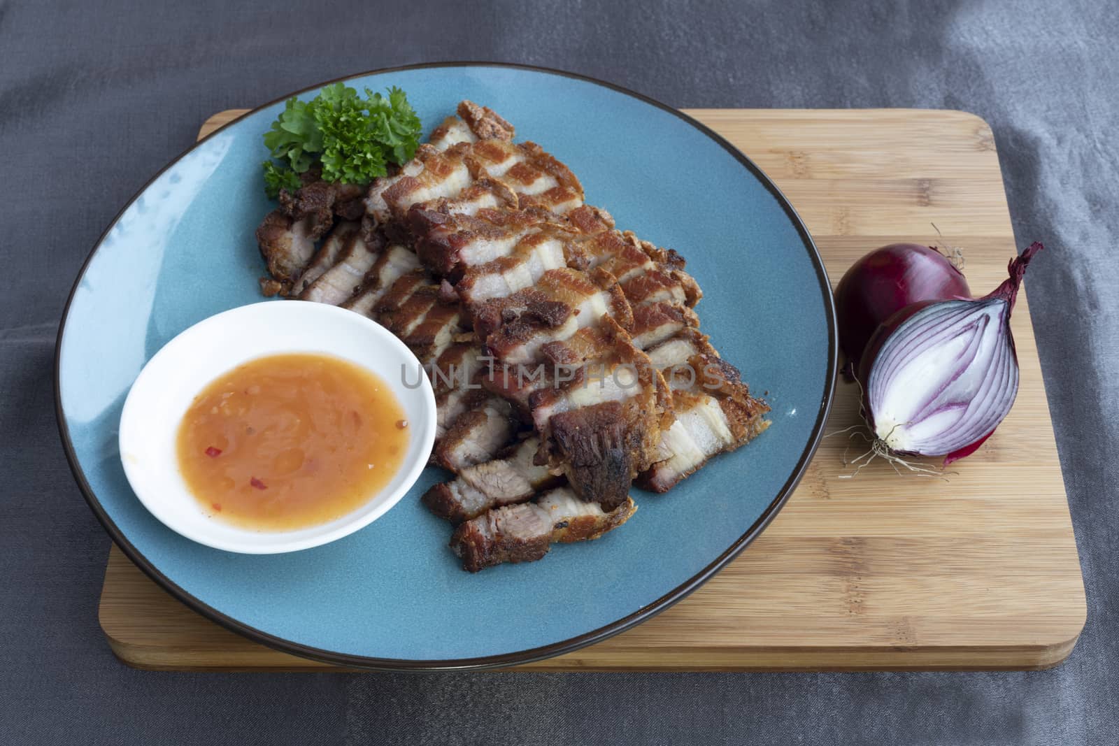 Siu Yuk, crispy fried pork belly service with tomato sauce and basil