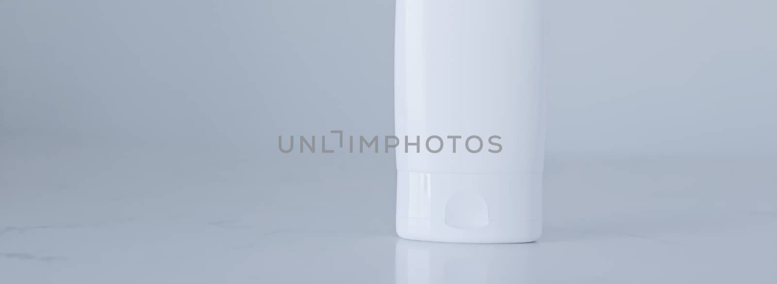 Blank label cosmetic container bottle as product mockup on gray background, hygiene and healthcare