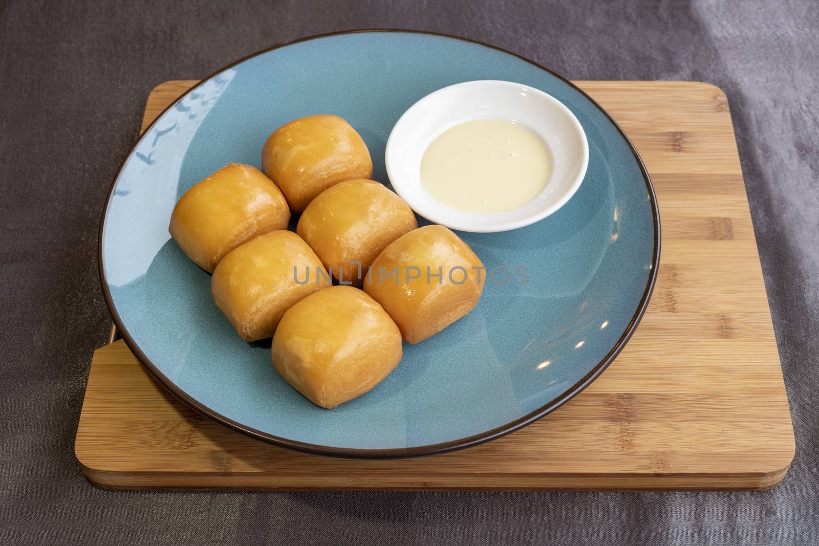 Fried chinese buns served with condensed sweet milk