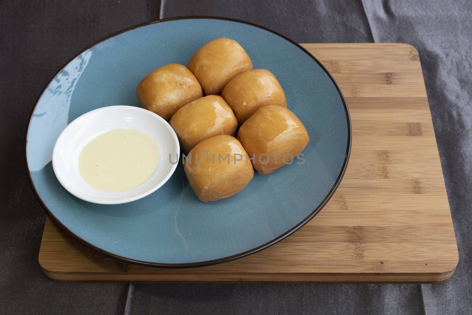 Fried chinese buns served with condensed sweet milk