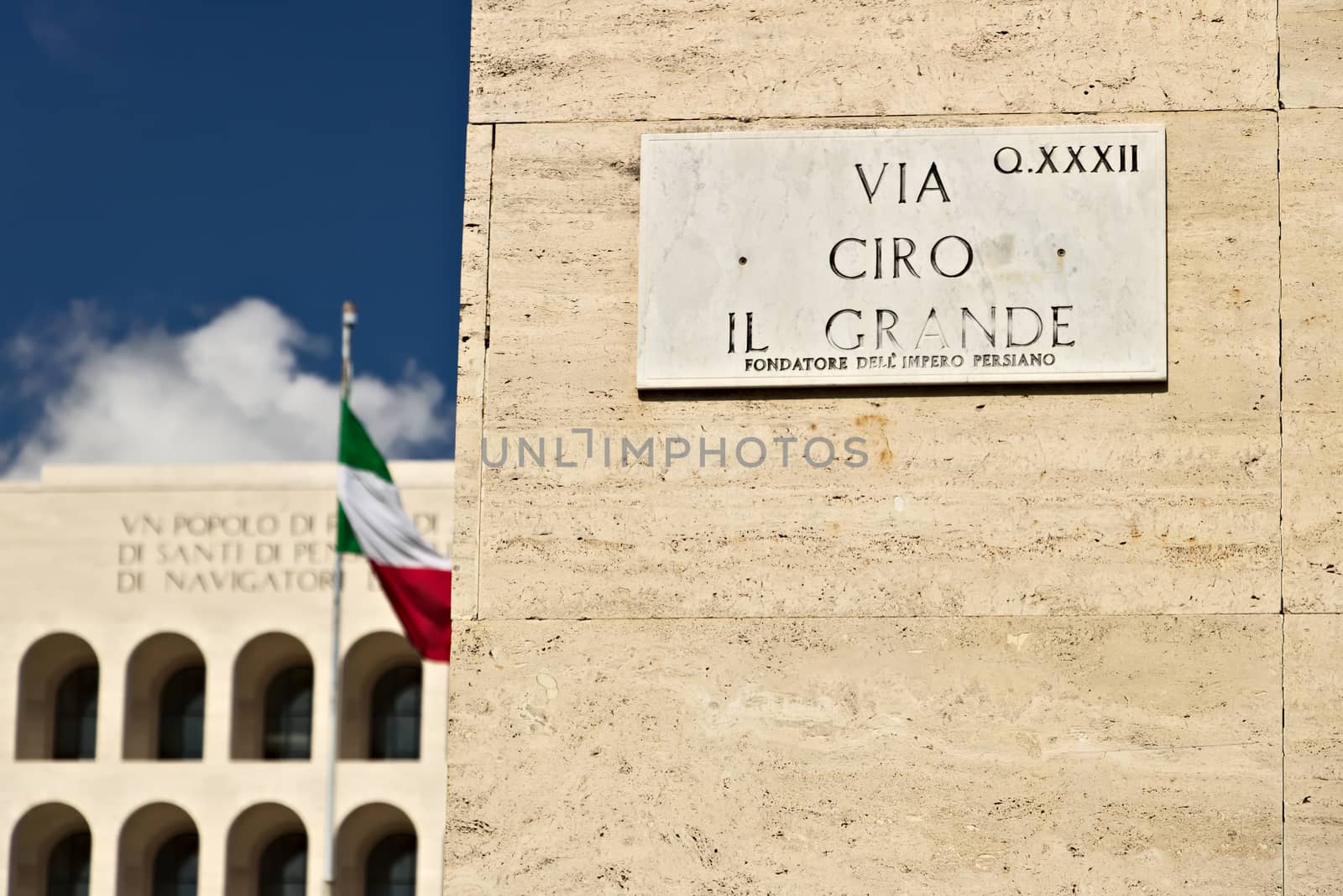 Street Sign Via Ciro the Great at the Eur. Road where the INPS is located in Rome. Rome Eur, Italy. 05/03/2019. In the background the palace of Italian civilization and the flag.