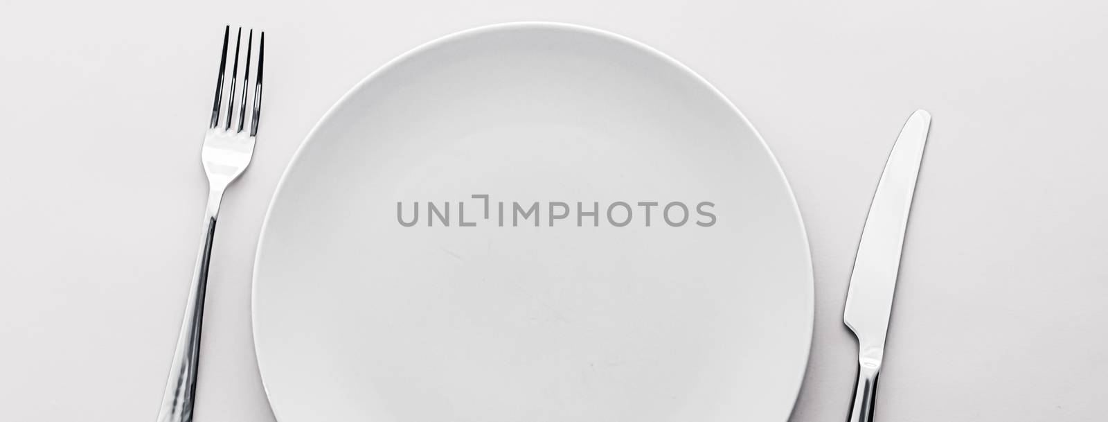 Empty plate and cutlery as mockup set on white background, top tableware for chef table decor and menu branding design