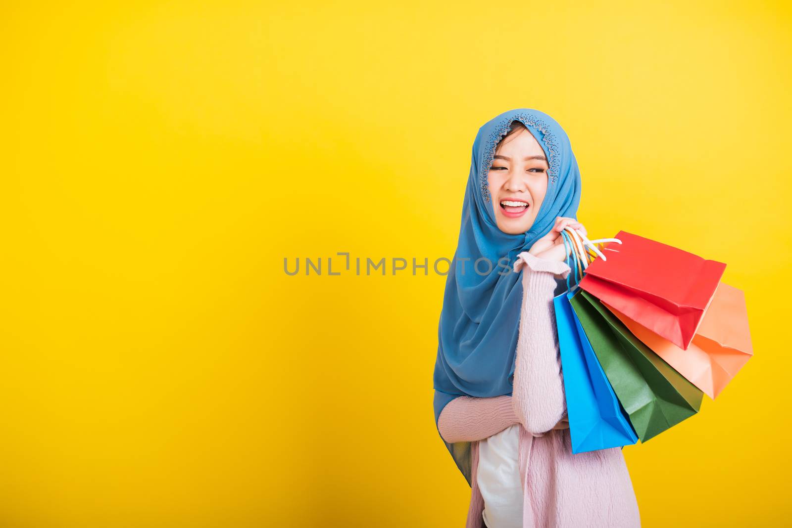Asian Muslim Arab woman Islam wear hijab smile she holding color by Sorapop