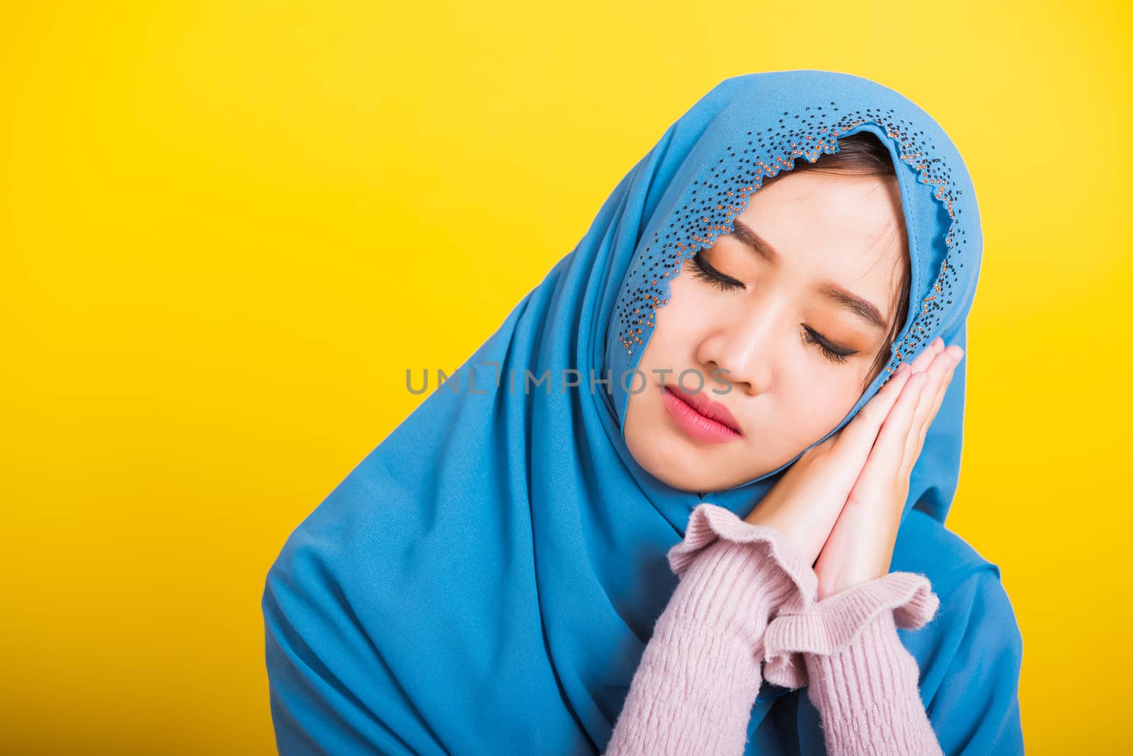 Asian Muslim Arab, Portrait of happy beautiful young woman Islam religious wear veil hijab funny smile she emotions tired sleepy her posing sleeping to dreaming with hands together near face, isolated