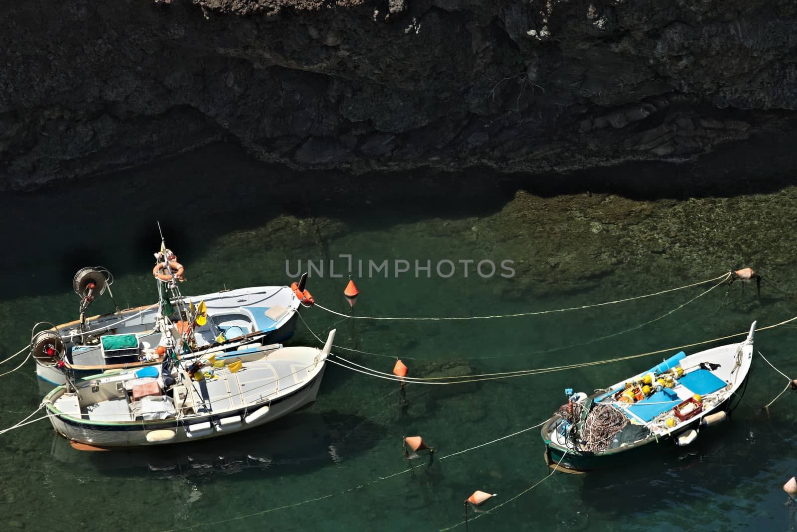 Fishing boats in the harbor. View from above. In the village of Framura, near the Cinque Terre a blue sea and dreamlike landscapes.