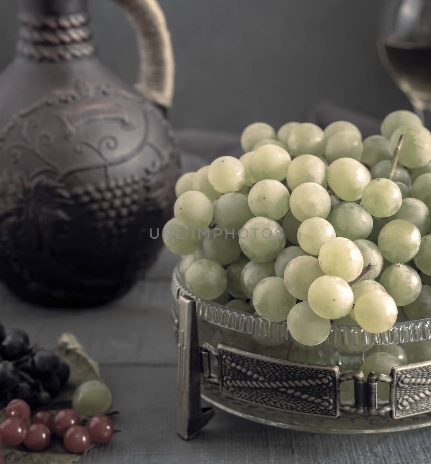 Grapes and wine in a jug and glasses by georgina198