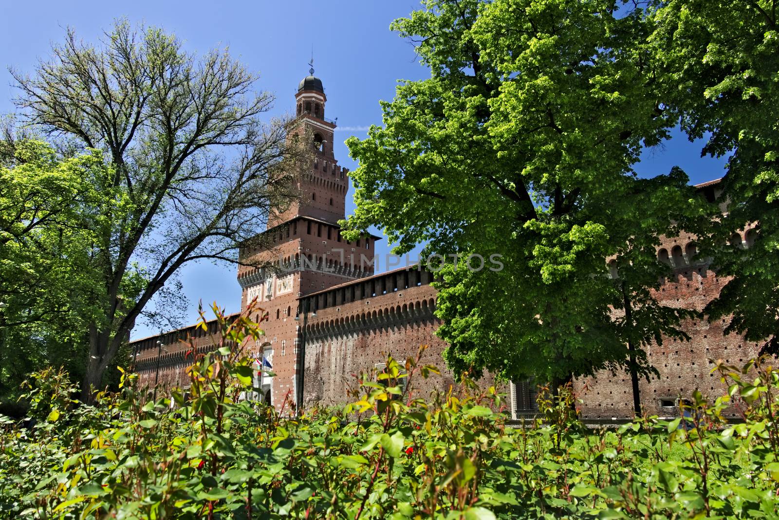 Milan, Lombardy, Italy, 04/27/2019. Sforza Castle. Tower with clock. The tower that overlooks the entrance to the walls of the castle of Milano. 