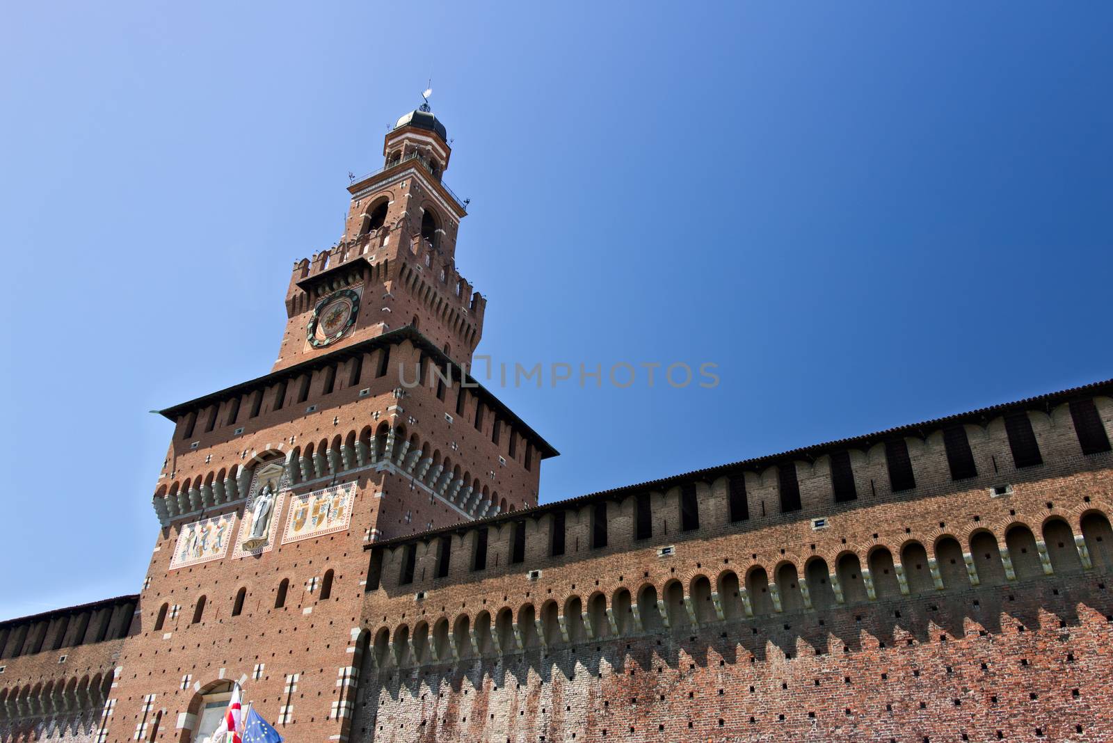 Milan, Lombardy, Italy, 04/27/2019. Sforza Castle. Tower with clock. The tower that overlooks the entrance to the walls of the castle of Milano. 