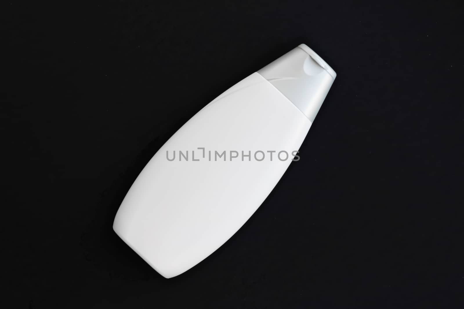 Blank label cosmetic container bottle as product mockup on black background, hygiene and healthcare