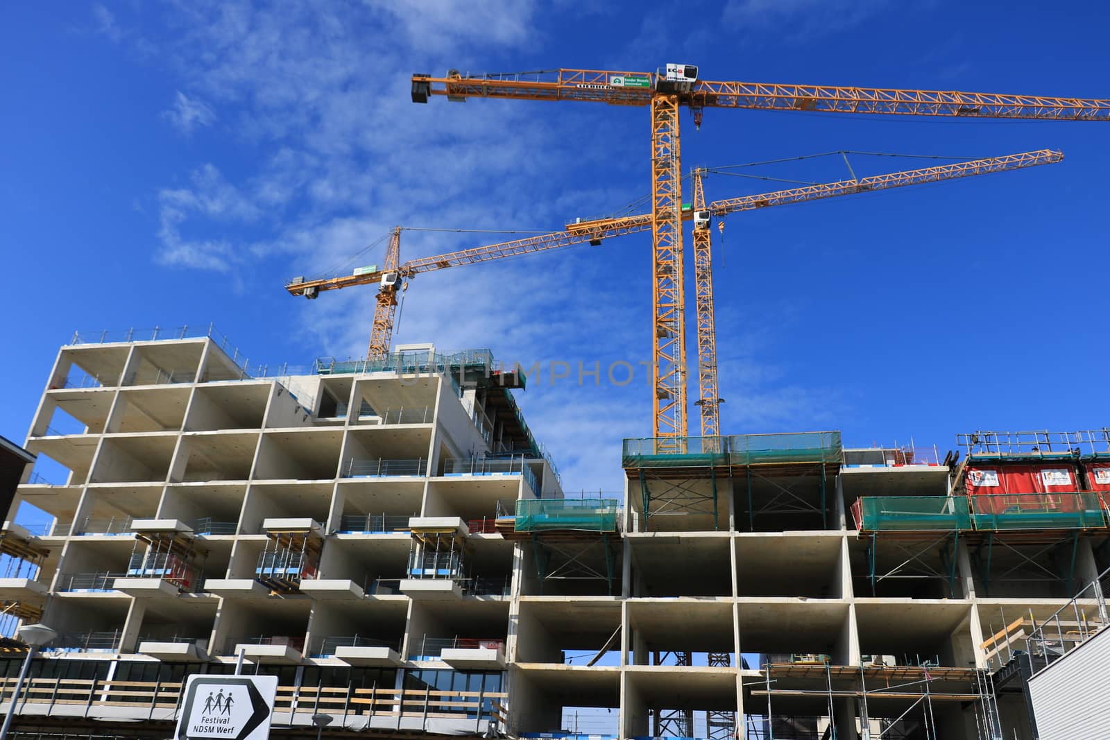 Amsterdam, Netherlands. About the July 2019. Construction site with cranes in Amsterdam. Construction of a new reinforced concrete building.