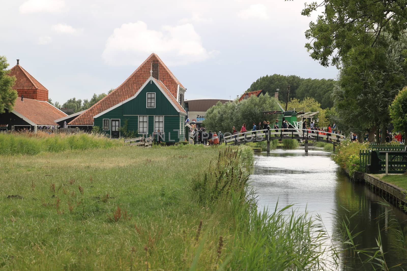 Zaanse Schans, Netherlands. About the July 2019.  Typical Dutch houses on the canal near Amsterdam. In the land of windmills there are many traditional houses along the river.