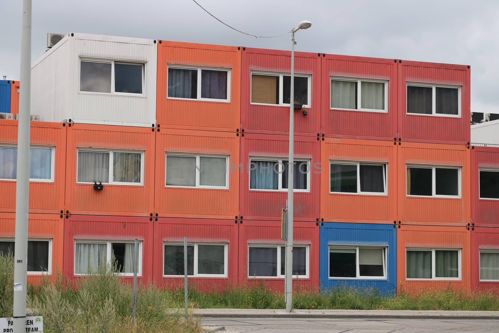 Amsterdam, NDSM, Netherlands. About the July 2019. Temporary housing in steel containers. Overlapping containers with small construction site apartments.