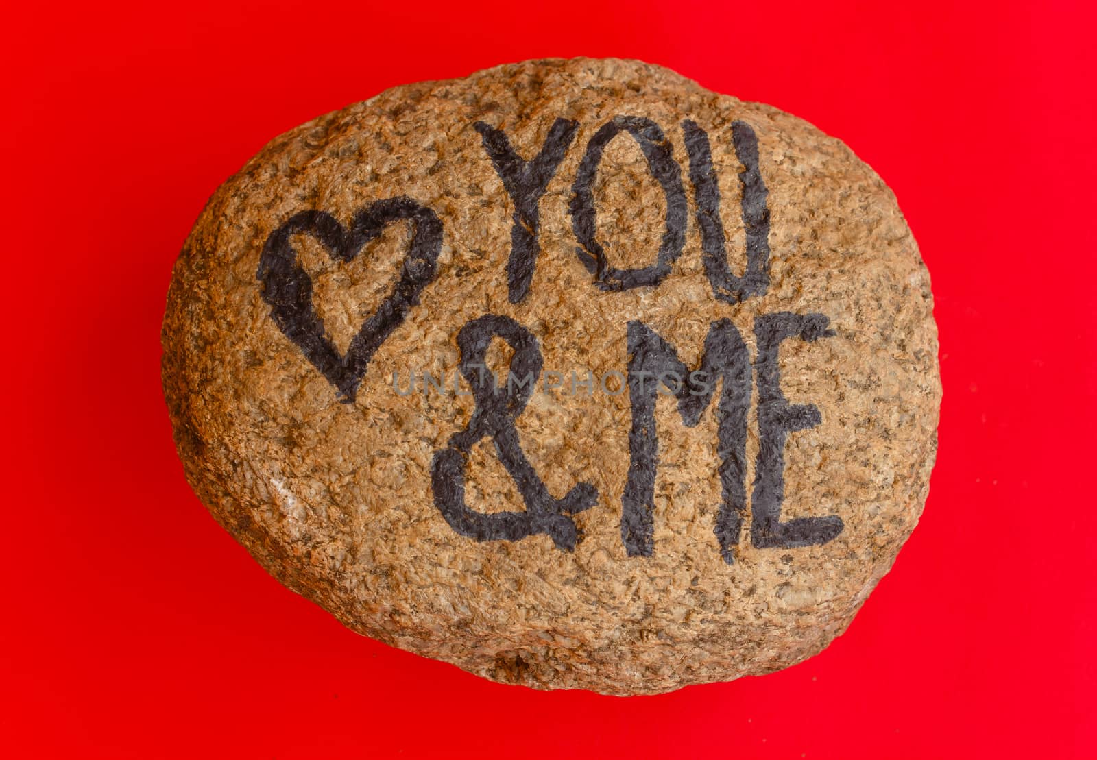 the english  writing you and me with a heart drawn on a stone by grancanaria