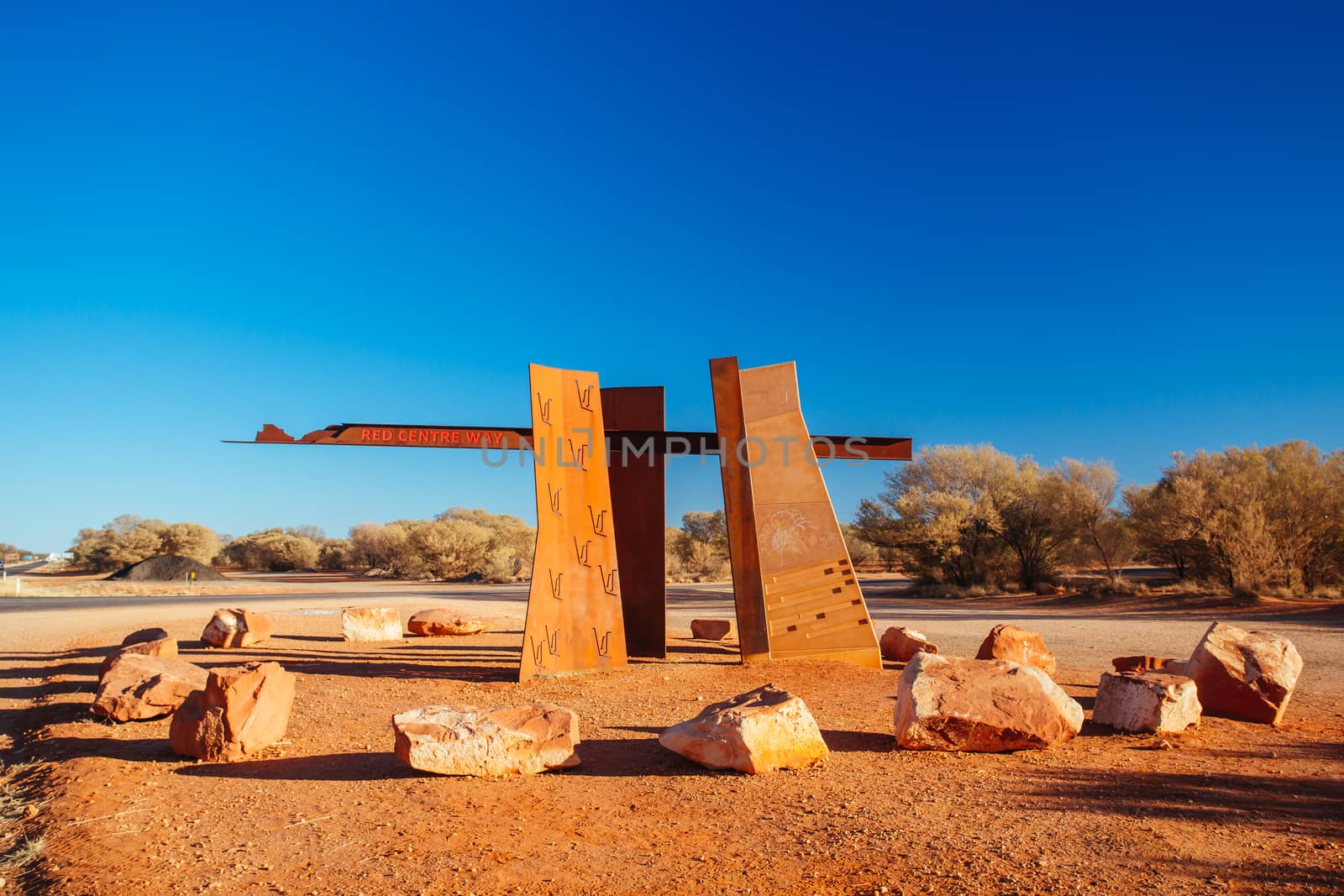 A marker and information spot for Lasseter Hwy directing towards Uluru and Kings Canyon in the Northern Territory, Australia